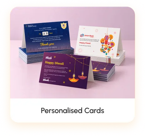 Printed Diwali greeting cards in three designs, standing in front of their own stacks
