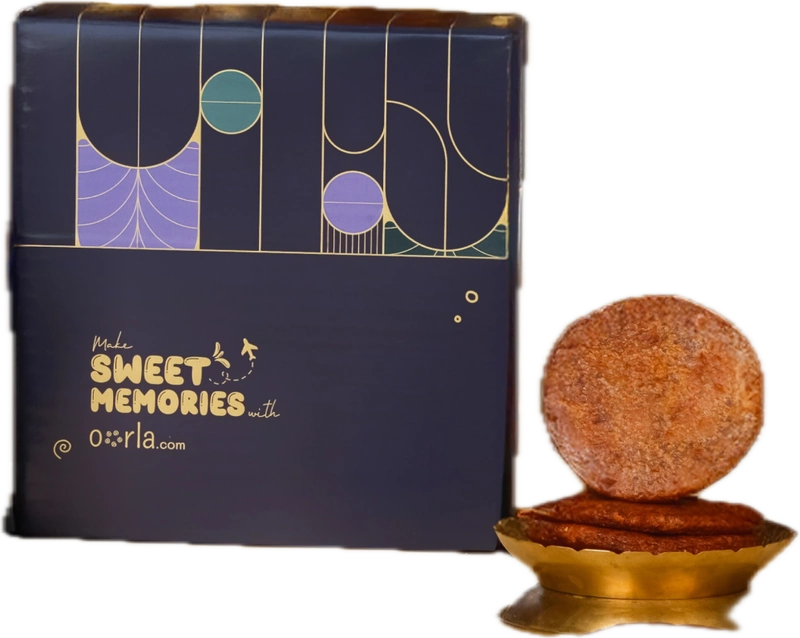 A navy rigid box with gold foil line art and 'Make sweet memories with oorla.com', beside adhirasams on a brass stand