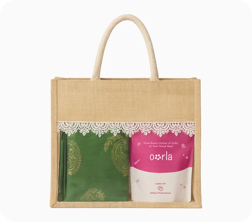 A laminated jute gift bag with a lace panel, holding a green silk drape and an Oorla retail pouch